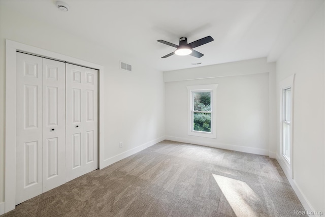 11240 Silver Lake Rd, Byron, MI 48418 - unfurnished bedroom with carpet flooring, a closet, and ceiling fan