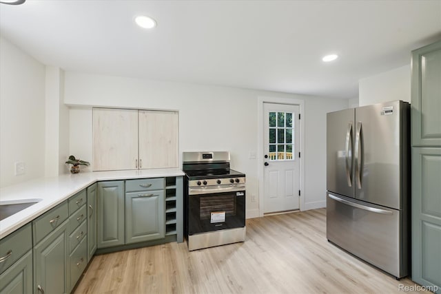 11240 Silver Lake Rd, Byron, MI 48418 - kitchen with stainless steel appliances, light wood-type flooring, light countertops, green cabinets, and recessed lighting