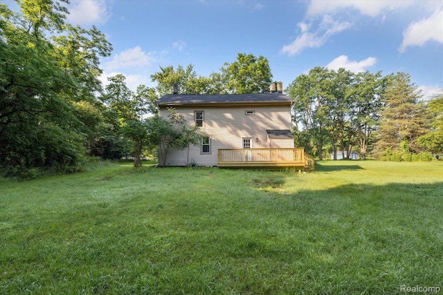 11240 Silver Lake Rd, Byron, MI 48418 - back of house with a deck, a chimney, and a lawn