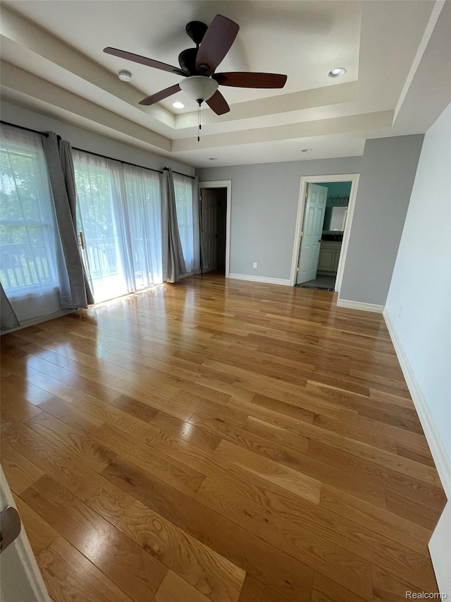 23364 Clark Rd, Belleville, MI 48111 - spare room with a raised ceiling, light wood-style flooring, a ceiling fan, a smoke detector, and recessed lighting