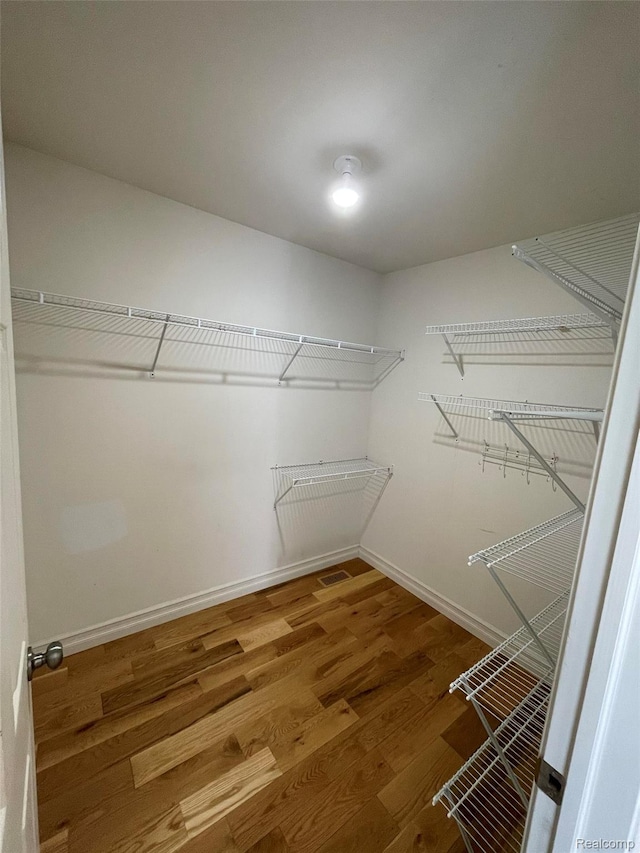 23364 Clark Rd, Belleville, MI 48111 - walk in closet featuring wood finished floors