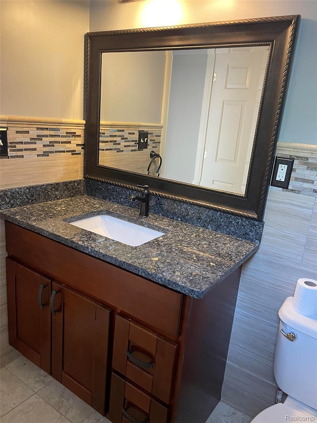23364 Clark Rd, Belleville, MI 48111 - half bath with tile walls, vanity, wainscoting, and tile patterned floors