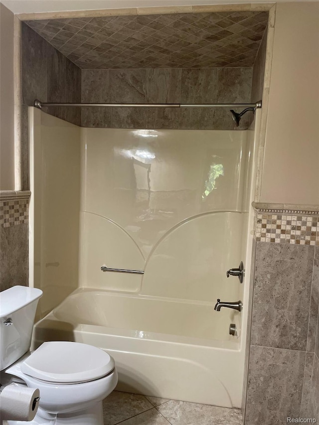 23364 Clark Rd, Belleville, MI 48111 - bathroom featuring tile walls, tub / shower combination, and tile patterned flooring