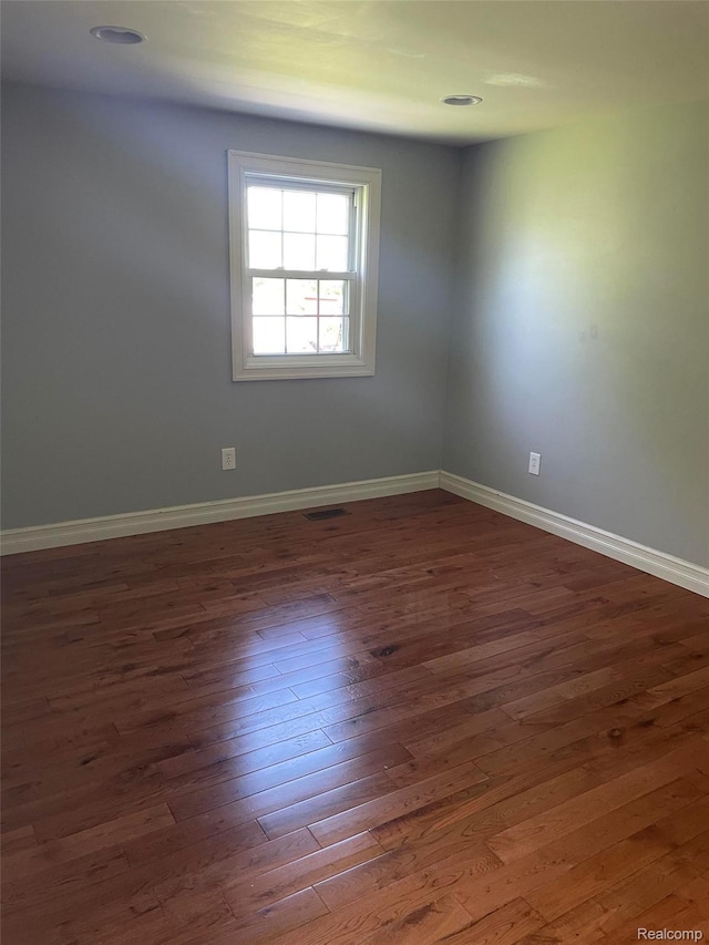 23364 Clark Rd, Belleville, MI 48111 - spare room featuring dark wood-type flooring and baseboards