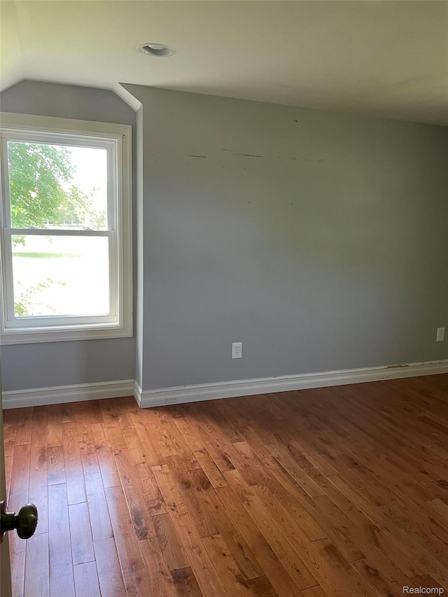 23364 Clark Rd, Belleville, MI 48111 - empty room with hardwood / wood-style flooring and lofted ceiling