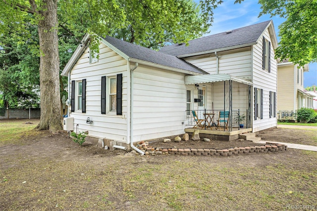 124 N Line St, Chesaning, MI 48616 - view of front of house featuring a porch and a shingled roof