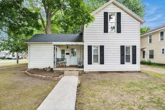 124 N Line St, Chesaning, MI 48616 - traditional-style home featuring a porch and roof with shingles