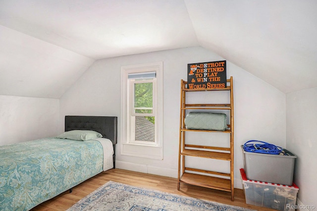 124 N Line St, Chesaning, MI 48616 - bedroom featuring lofted ceiling and wood finished floors