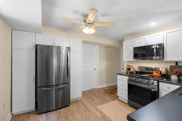 5743 107th Ave, Pullman, MI 49450 - kitchen with appliances with stainless steel finishes, dark countertops, white cabinets, light wood-style floors, and a ceiling fan