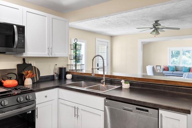 5743 107th Ave, Pullman, MI 49450 - kitchen with stainless steel appliances, healthy amount of natural light, dark countertops, and a textured ceiling