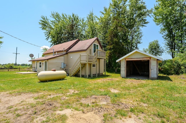 5743 107th Ave, Pullman, MI 49450 - view of side of property featuring a lawn, an outdoor structure, a deck, and stairs
