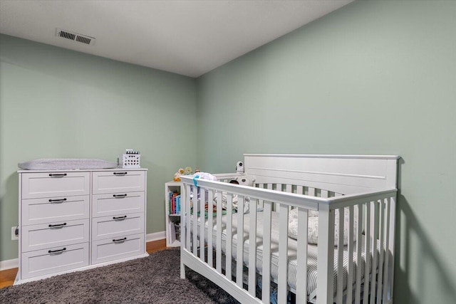 34066 Orangelawn St, Livonia, MI 48150 - bedroom featuring a crib and dark carpet