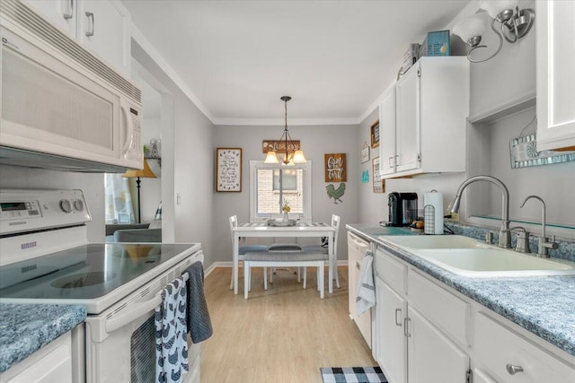 34066 Orangelawn St, Livonia, MI 48150 - kitchen featuring white appliances, white cabinets, light wood-style floors, pendant lighting, and light countertops
