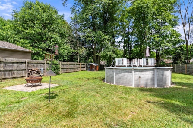 34066 Orangelawn St, Livonia, MI 48150 - fenced backyard with an outdoor fire pit and view of wooded area