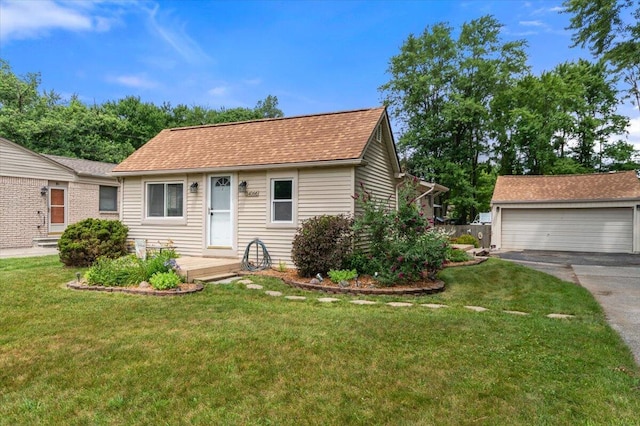 34066 Orangelawn St, Livonia, MI 48150 - view of front facade featuring a front yard, a detached garage, an outdoor structure, and roof with shingles