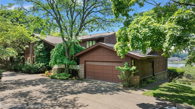 3350 Franklin Rd, Bloomfield Hills, MI 48302 - view of front of property with asphalt driveway, an attached garage, a water view, and a shingled roof