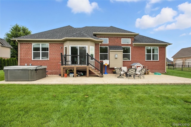 27245 Ritter Blvd, Flat Rock, MI 48134 - rear view of property featuring a hot tub, a patio area, and brick siding