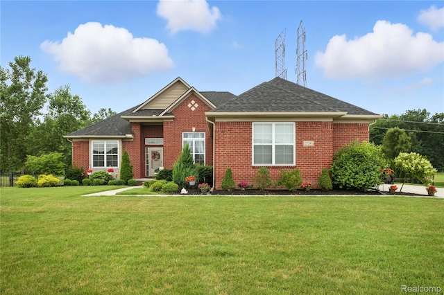 27245 Ritter Blvd, Flat Rock, MI 48134 - view of front of home featuring brick siding, a front yard, and a shingled roof
