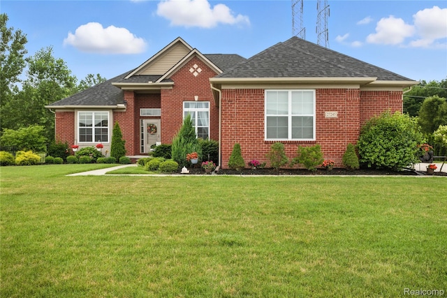 27245 Ritter Blvd, Flat Rock, MI 48134 - view of front of property featuring brick siding, a front lawn, and a shingled roof