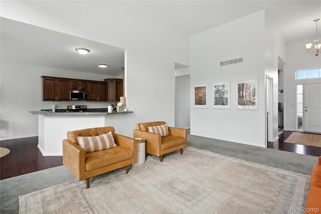 27245 Ritter Blvd, Flat Rock, MI 48134 - living area featuring a chandelier, a towering ceiling, and wood finished floors