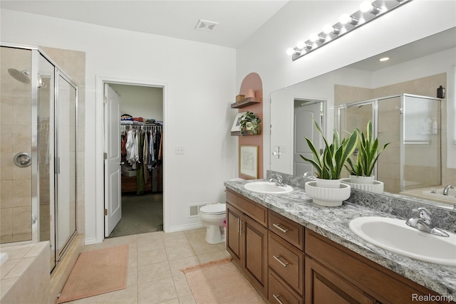 27245 Ritter Blvd, Flat Rock, MI 48134 - bathroom with double vanity, a stall shower, a bath, and tile patterned floors