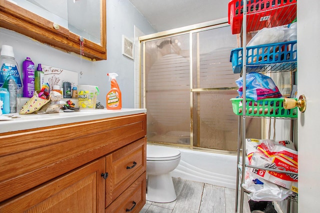 1638 Superior St, Niles, MI 49120 - bathroom featuring vanity, shower / bath combination with glass door, and wood finished floors