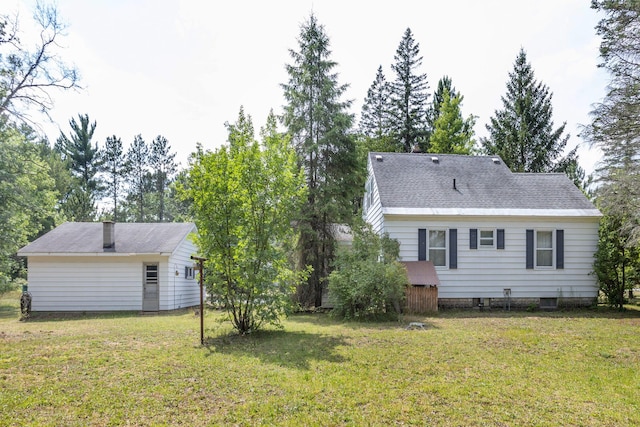 425 6th St, Baldwin, MI 49304 - back of house with a yard and a shingled roof