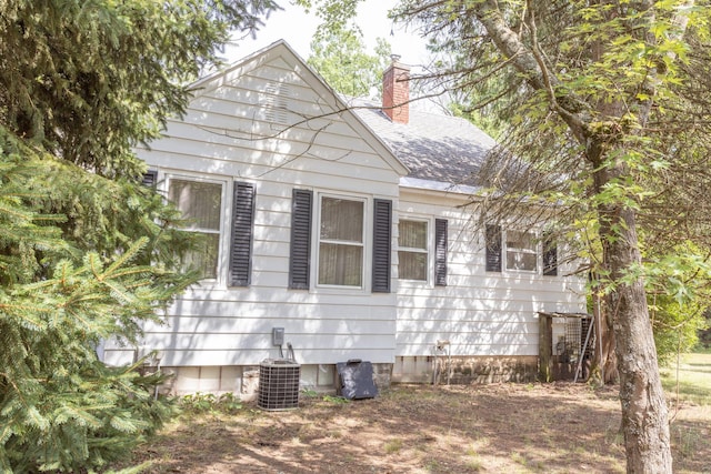 425 6th St, Baldwin, MI 49304 - view of home's exterior featuring a chimney and a shingled roof