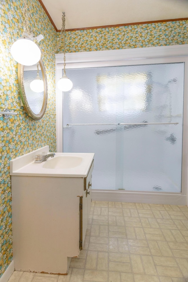 425 6th St, Baldwin, MI 49304 - full bathroom featuring wallpapered walls, vanity, crown molding, and a stall shower