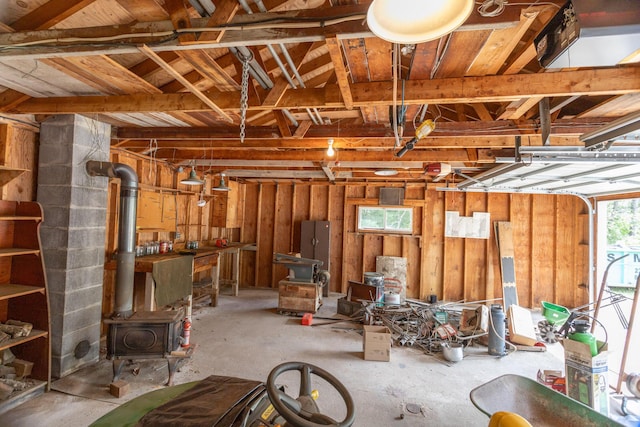 425 6th St, Baldwin, MI 49304 - garage featuring a wood stove