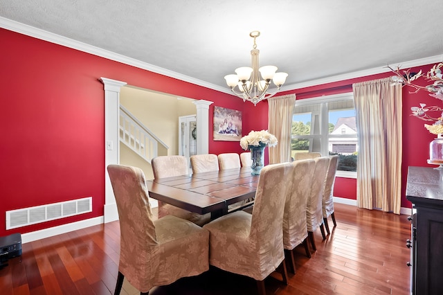 16069 Grazenview St, Schoolcraft, MI 49087 - dining space with a chandelier, wood-type flooring, decorative columns, ornamental molding, and stairs