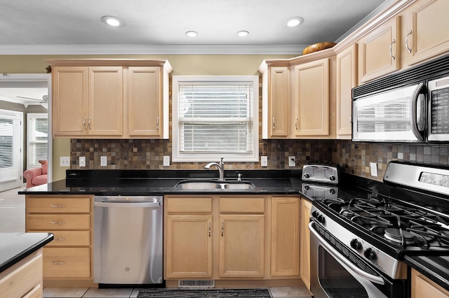 16069 Grazenview St, Schoolcraft, MI 49087 - kitchen featuring appliances with stainless steel finishes, light brown cabinetry, dark countertops, and crown molding