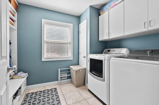 16069 Grazenview St, Schoolcraft, MI 49087 - laundry room with washer and dryer, cabinet space, and light tile patterned flooring