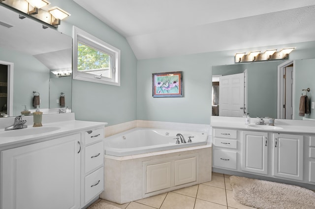 16069 Grazenview St, Schoolcraft, MI 49087 - full bath with vaulted ceiling, two vanities, a garden tub, and tile patterned floors