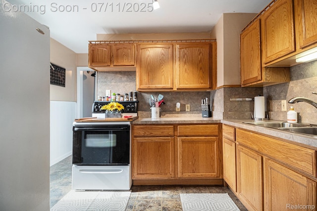32247 Annapolis St, Wayne, MI 48184 - kitchen with range with electric stovetop, freestanding refrigerator, light countertops, tasteful backsplash, and wainscoting