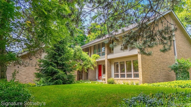 26311 W 14 Mile Rd, Franklin, MI 48025 - view of front of property with brick siding and a front yard