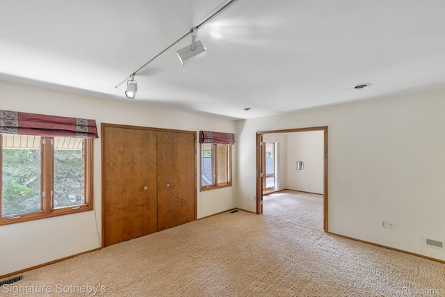 26311 W 14 Mile Rd, Franklin, MI 48025 - unfurnished bedroom featuring carpet floors, a closet, and track lighting