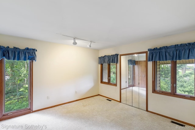 26311 W 14 Mile Rd, Franklin, MI 48025 - unfurnished bedroom featuring rail lighting, carpet floors, and a closet