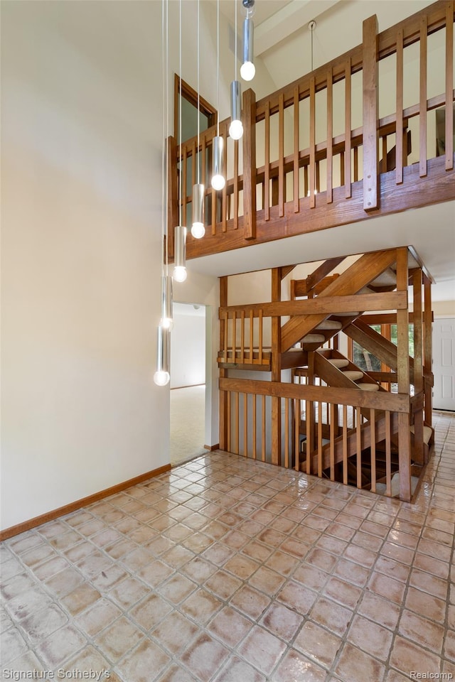 26311 W 14 Mile Rd, Franklin, MI 48025 - stairs featuring baseboards and a high ceiling