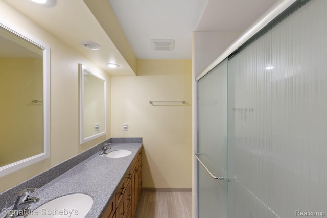 26311 W 14 Mile Rd, Franklin, MI 48025 - full bathroom with double vanity, wood finished floors, and an enclosed shower