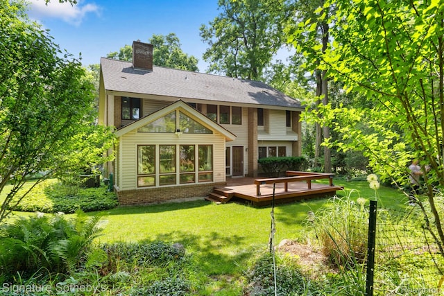 26311 W 14 Mile Rd, Franklin, MI 48025 - rear view of house featuring a wooden deck, a chimney, a lawn, brick siding, and a shingled roof