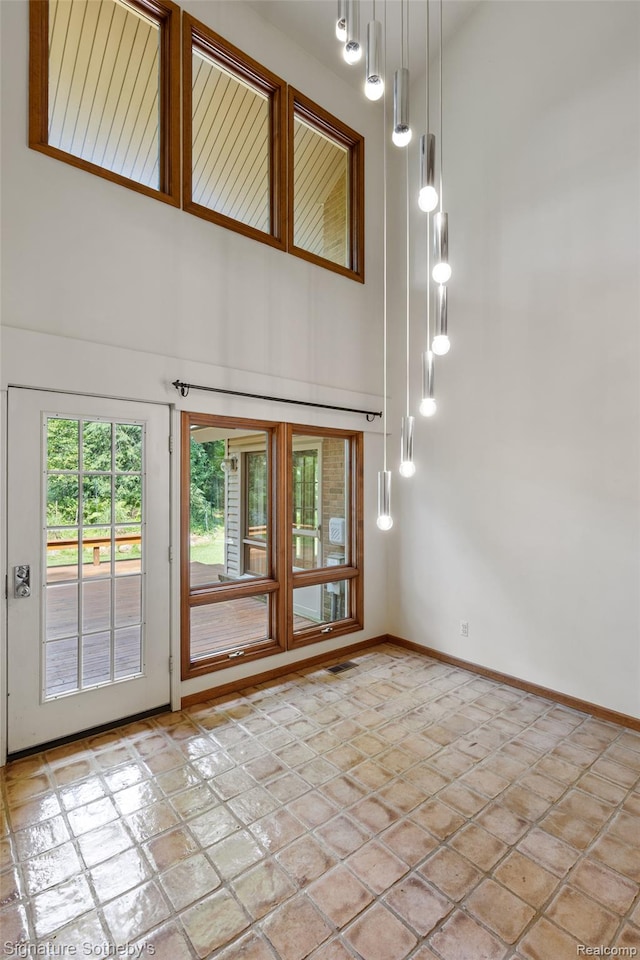 26311 W 14 Mile Rd, Franklin, MI 48025 - empty room with a towering ceiling and light stone finish floors