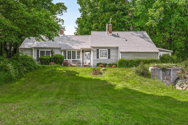 5515 Kaiser Rd, Sawyer, MI 49125 - view of front facade featuring a front lawn, a chimney, and roof with shingles