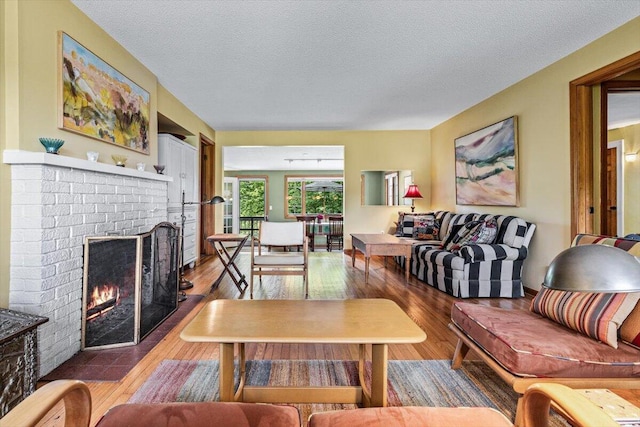 5515 Kaiser Rd, Sawyer, MI 49125 - living area featuring a fireplace, hardwood / wood-style flooring, and a textured ceiling