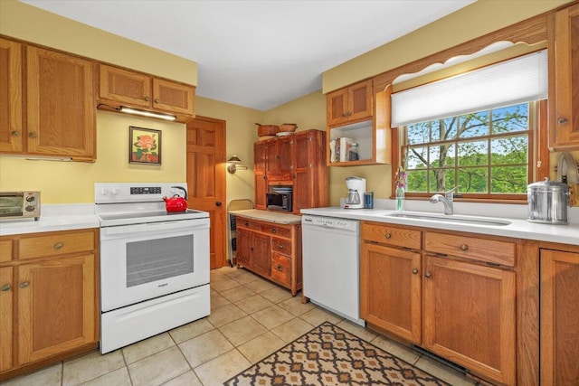 5515 Kaiser Rd, Sawyer, MI 49125 - kitchen with white appliances, light countertops, light tile patterned flooring, and brown cabinetry