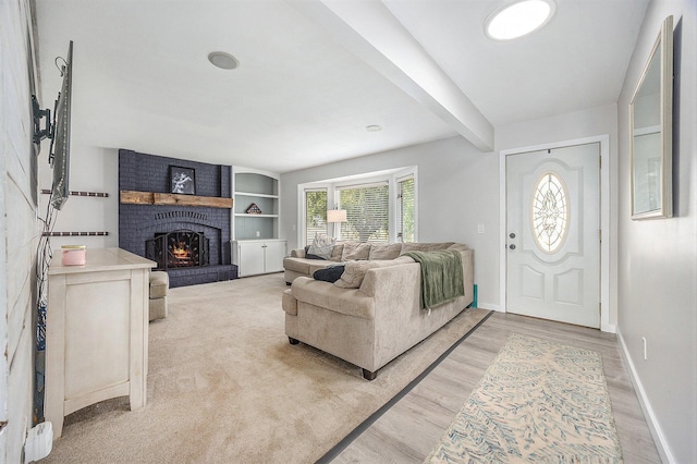1440 Chevelle, Jenison, MI 49428 - living area featuring a brick fireplace, beamed ceiling, and light wood-style floors