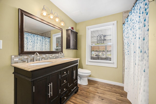 1440 Chevelle, Jenison, MI 49428 - full bathroom featuring double vanity, decorative backsplash, wood finished floors, and curtained shower