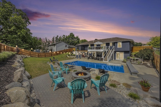 1440 Chevelle, Jenison, MI 49428 - pool at dusk featuring an outdoor fire pit, stairway, and a fenced backyard