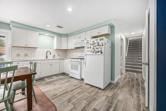 1440 Chevelle, Jenison, MI 49428 - kitchen with white appliances, light wood-type flooring, tasteful backsplash, white cabinets, and recessed lighting