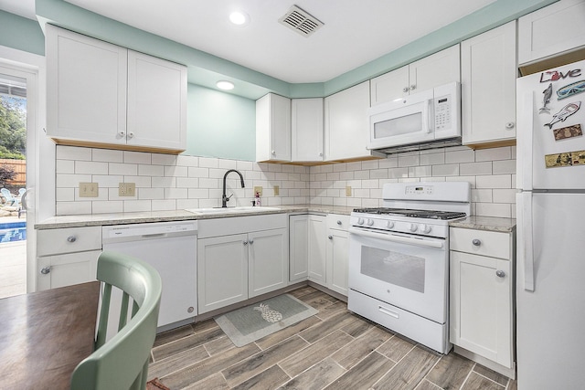 1440 Chevelle, Jenison, MI 49428 - kitchen with white appliances, recessed lighting, white cabinetry, light countertops, and light wood finished floors
